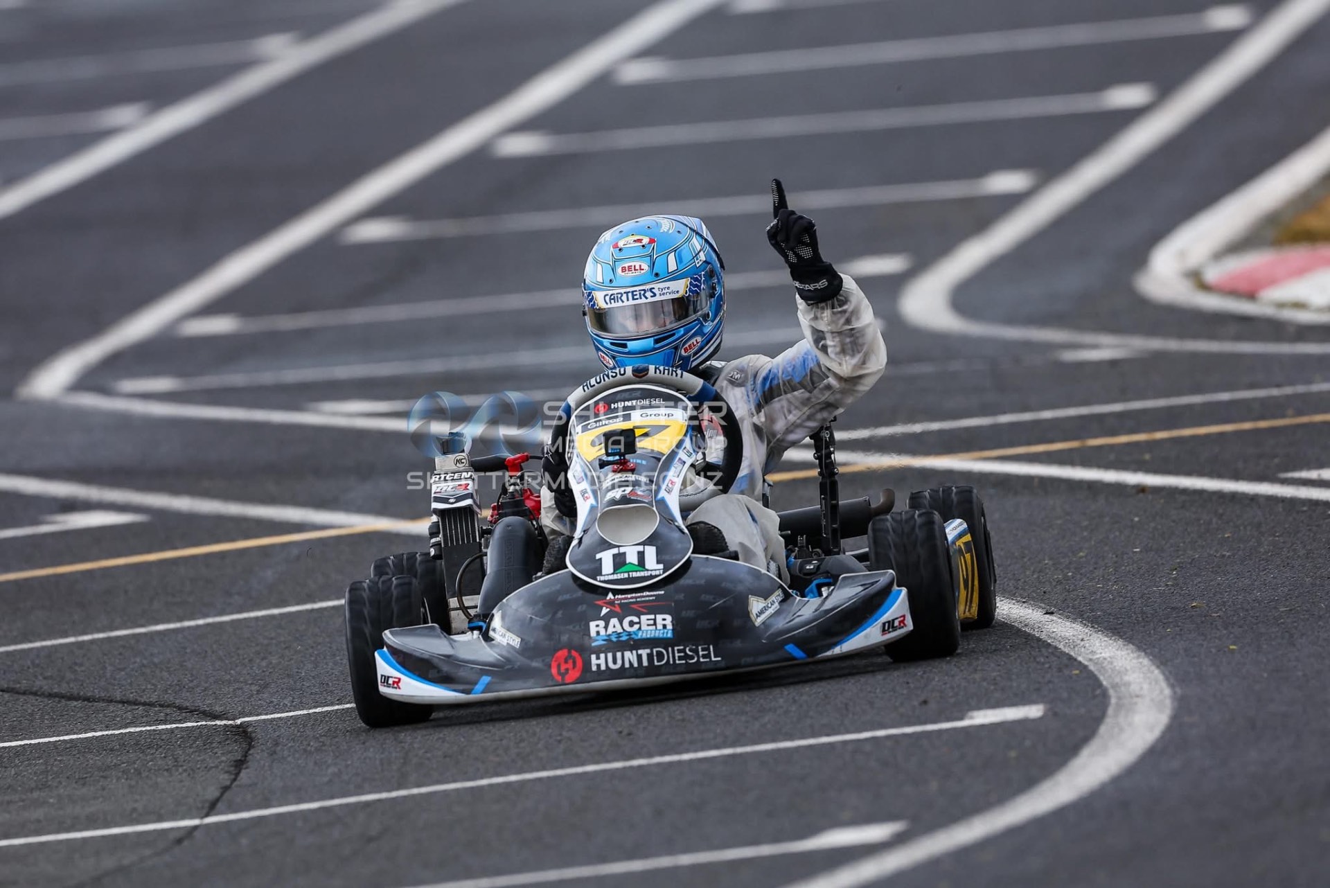 Nico Thomasen celebrating a race win with a finger raised on track