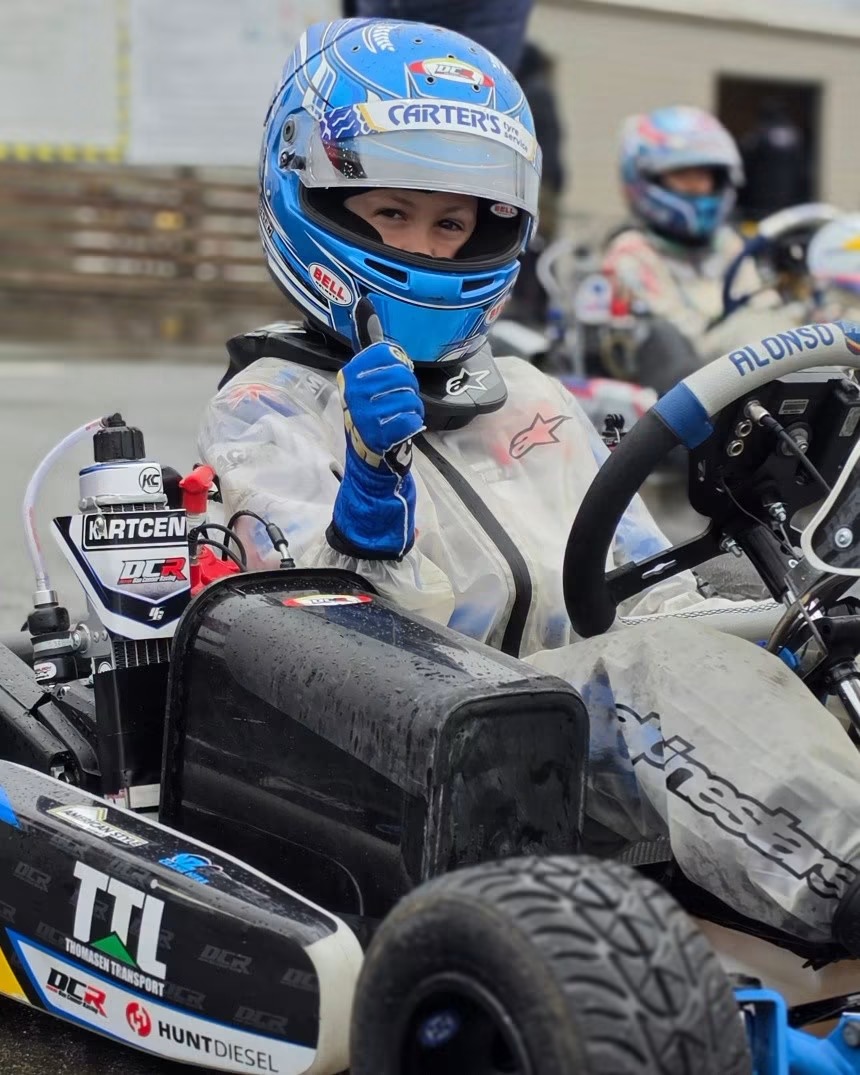 Nico Thomasen giving a thumbs up from his kart on the grid