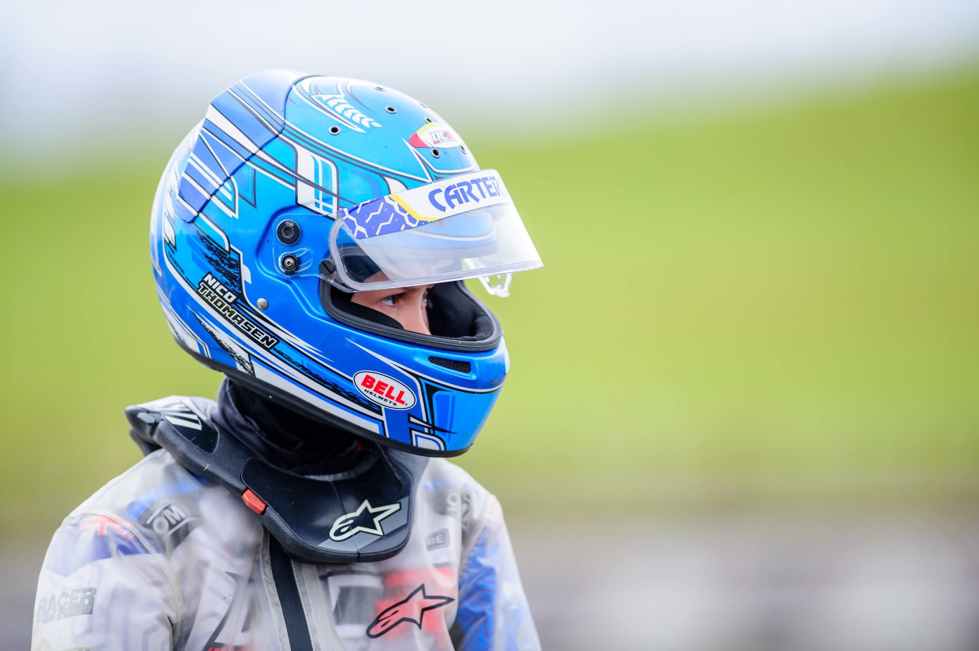 Nico Thomasen in his blue Bell helmet and rain jacket looking out over the track