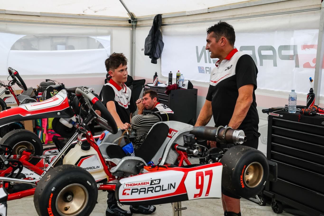 Nico Thomasen talking with his engineer in the Parolin paddock tent